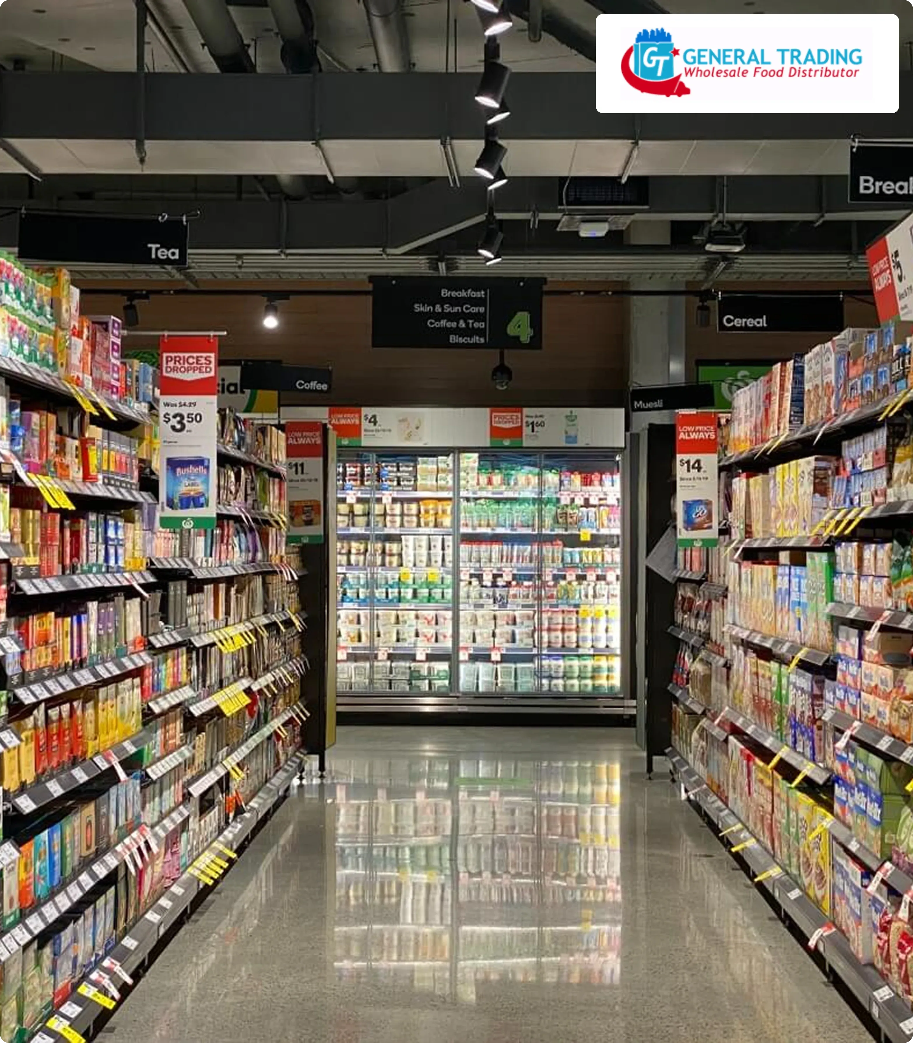 Store aisle displaying a variety of groceries on both sides, with a well-lit refrigerated section at the end. Bright, organized, and inviting. 