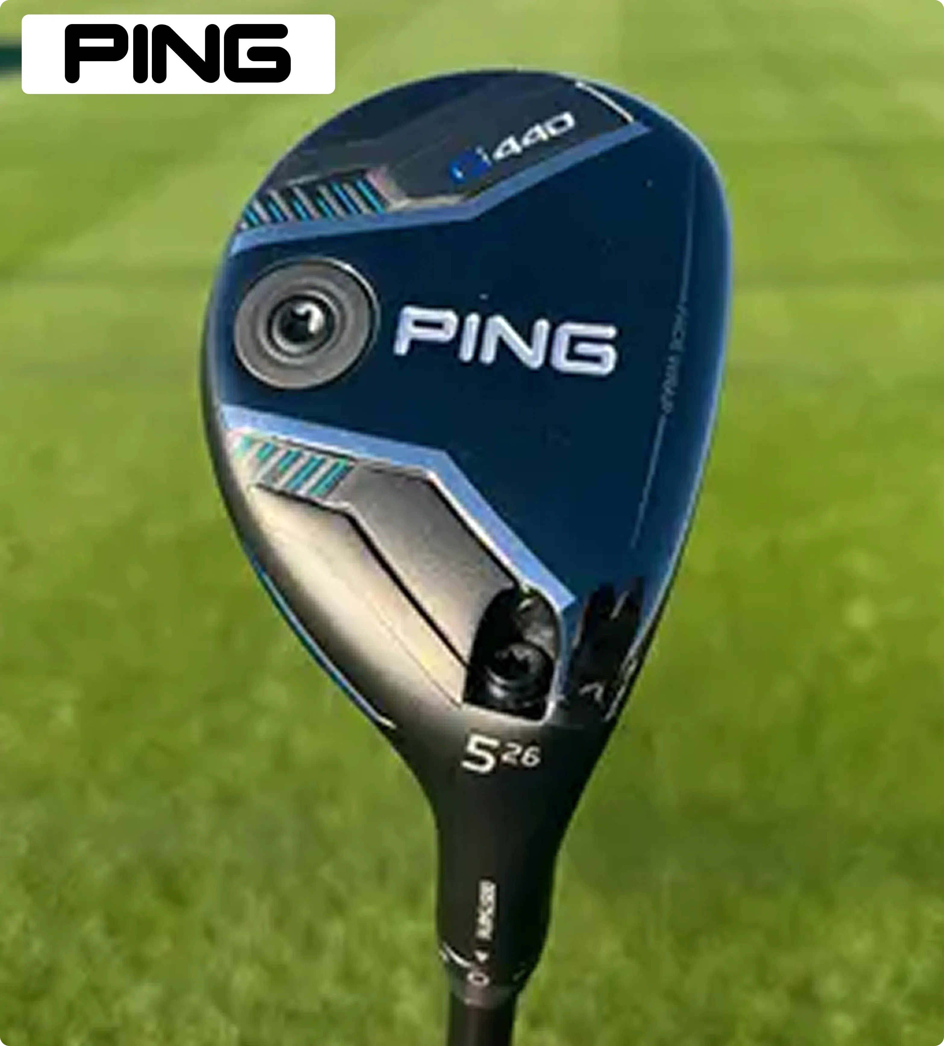 The image shows a PING golf club head, model G430, with a sleek blue and black design. It is set against a vibrant green grass background. 