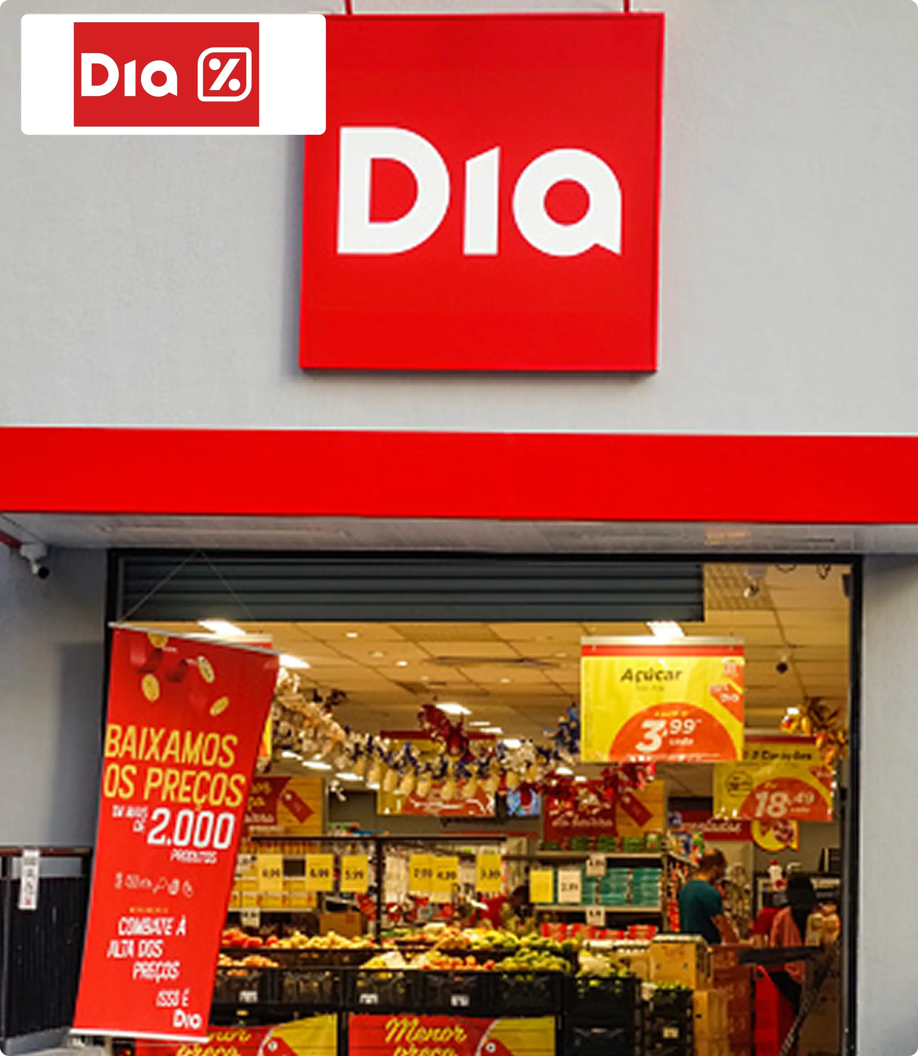 Storefront of Dia supermarket with red and white branding, sales banners, and visible produce displays, conveying a welcoming shopping atmosphere.